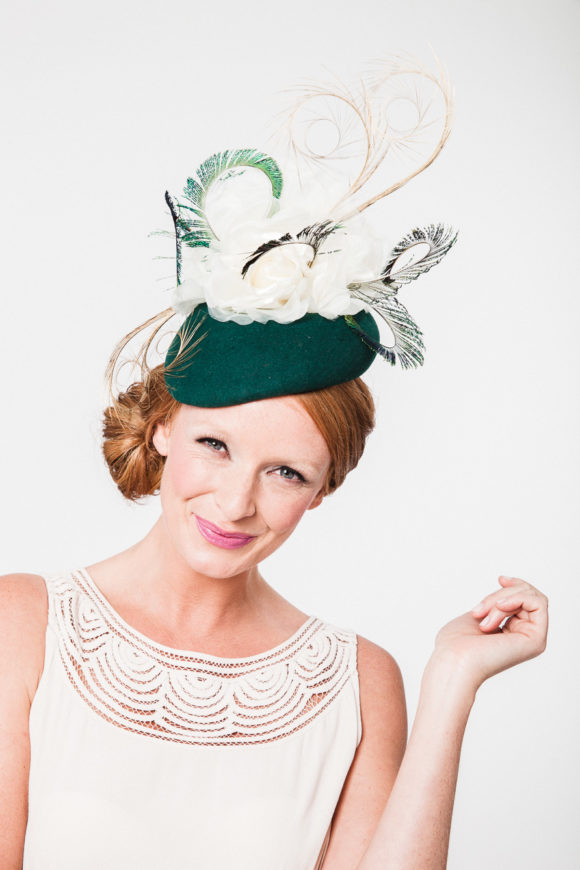 racing green beret with ivory silk rose and ornate curled peacock swords