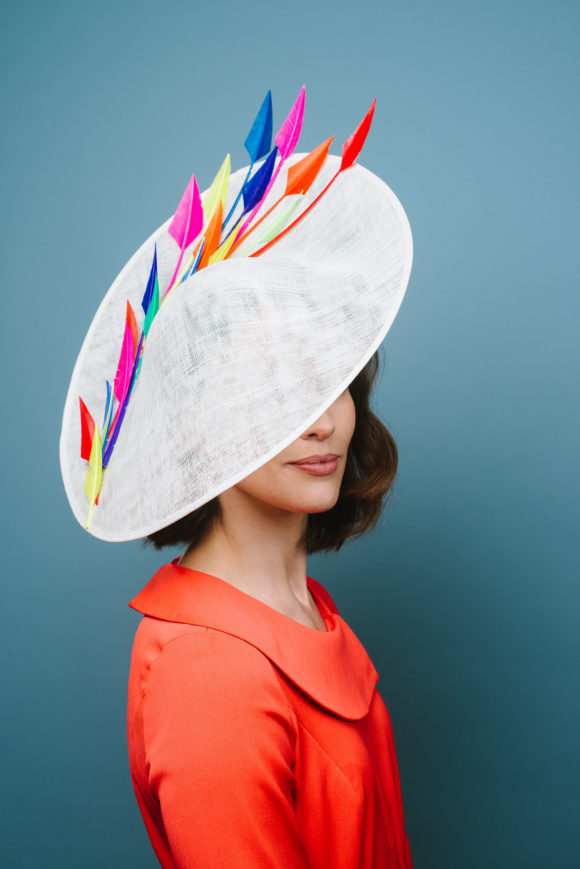 multi coloured feathers on ivory saucer