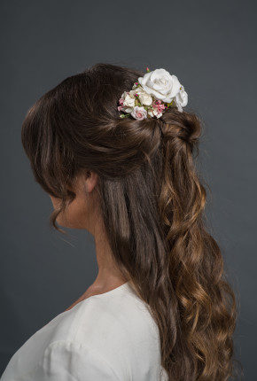 varying sizes of white and pink roses on a hairclip